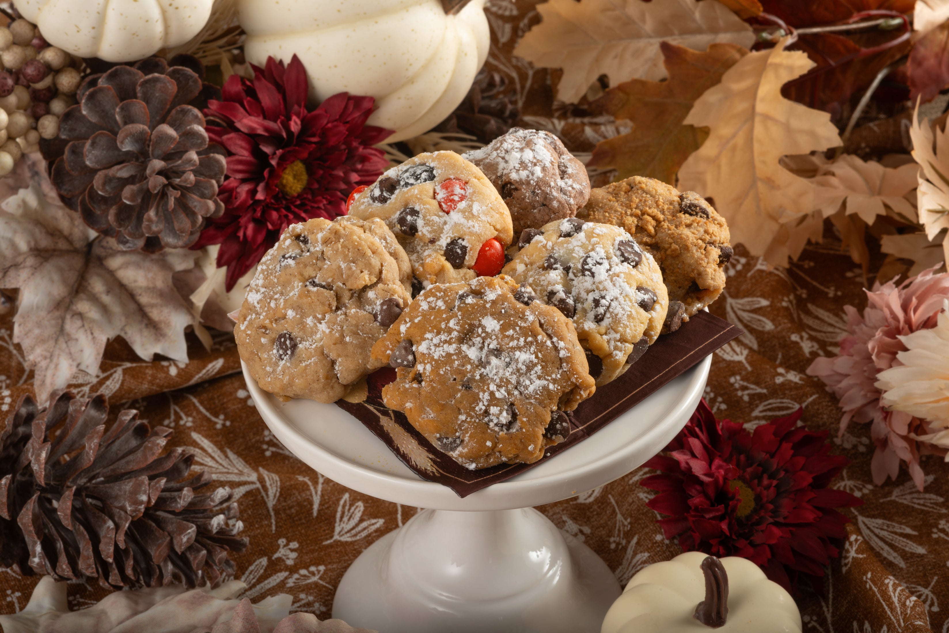 Pumpkin chocolate chip, chocolate chip, candied chocolate chip, and campfire cookies on a fall platter.