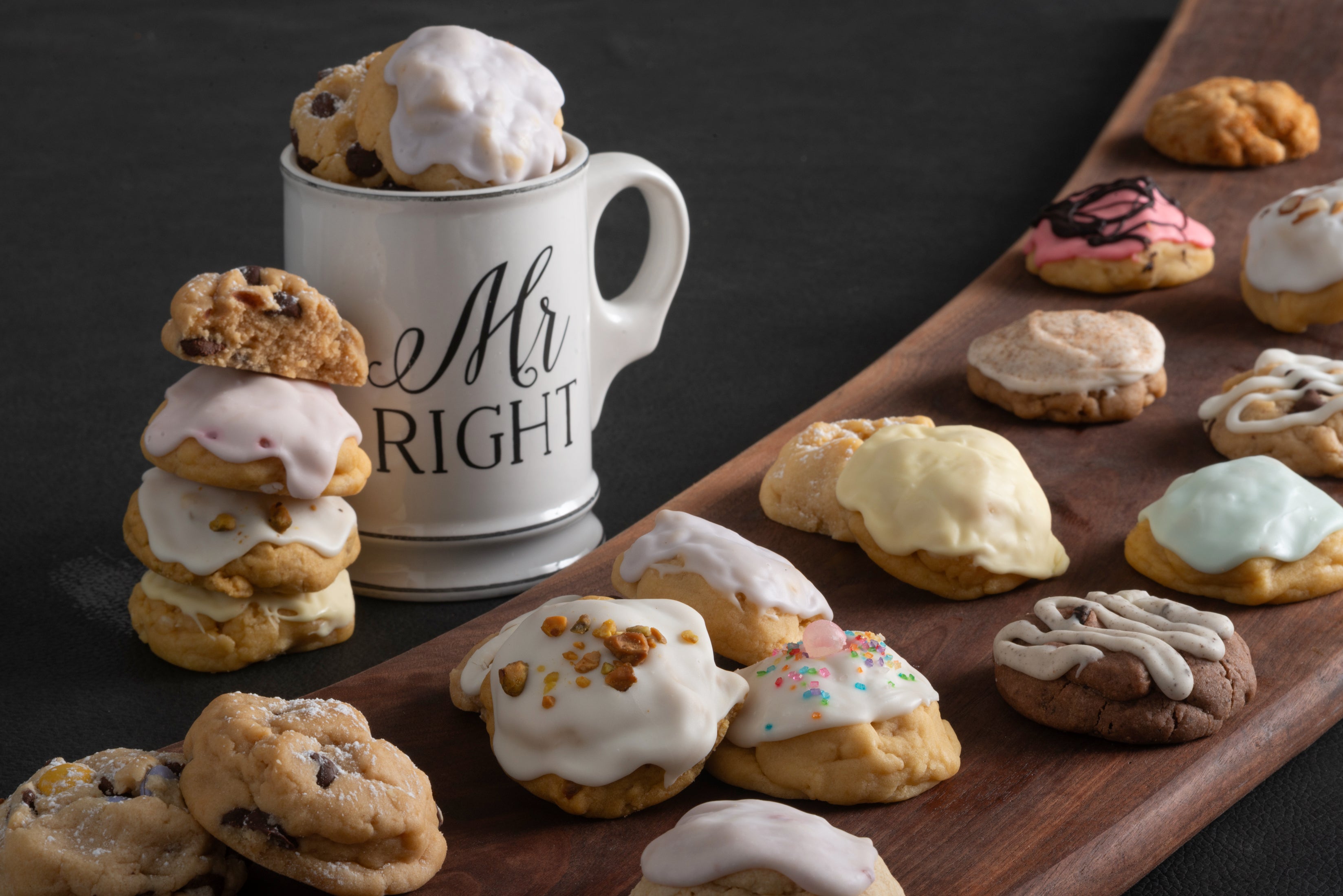 Mr. Right coffee mug with all our gourmet cookies on a wooden cutting board.