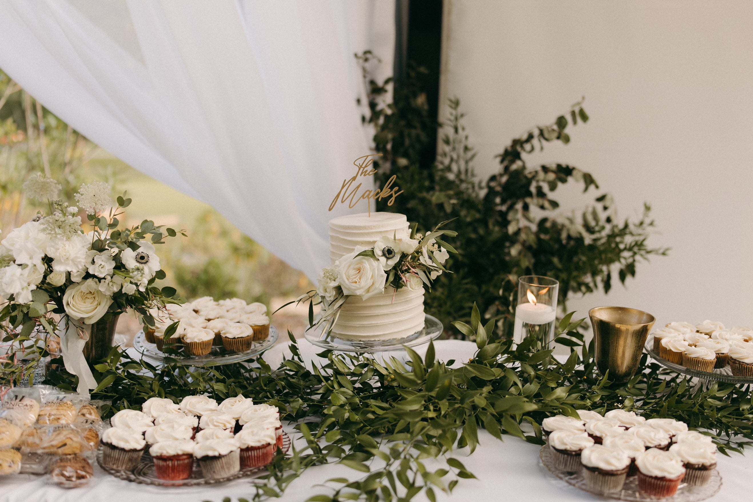 Wedding display of cookies and cupcakes.