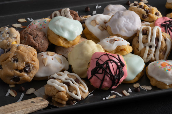 Serving up our handcrafted, freshly baked, gourmet cookies, featuring our Chocolate Chip, Caramel Rock, Naughty Almond, Iced Keylime, Iced Sugar Gems, Iced Almond, and Iced Lemon.