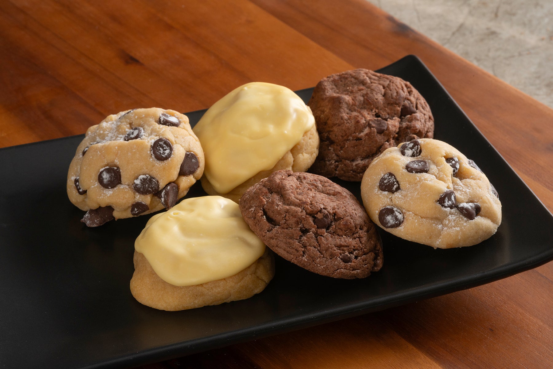 A platter of our Iced Lemon, Chocolate Brownie Grenade, and Chocolate Chip cookies.