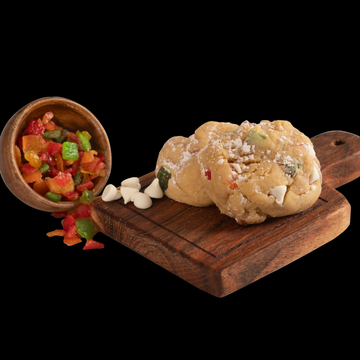 Our gourmet Not Your GG's Fruitcake cookie, made with candied peals, white chocolate, and powdered sugar.