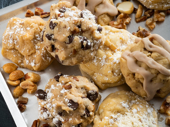 A baking tray featuring a collection of our nut cookies: Chocolate Chip Pecan, and White Chocolate Almond Macadmia.