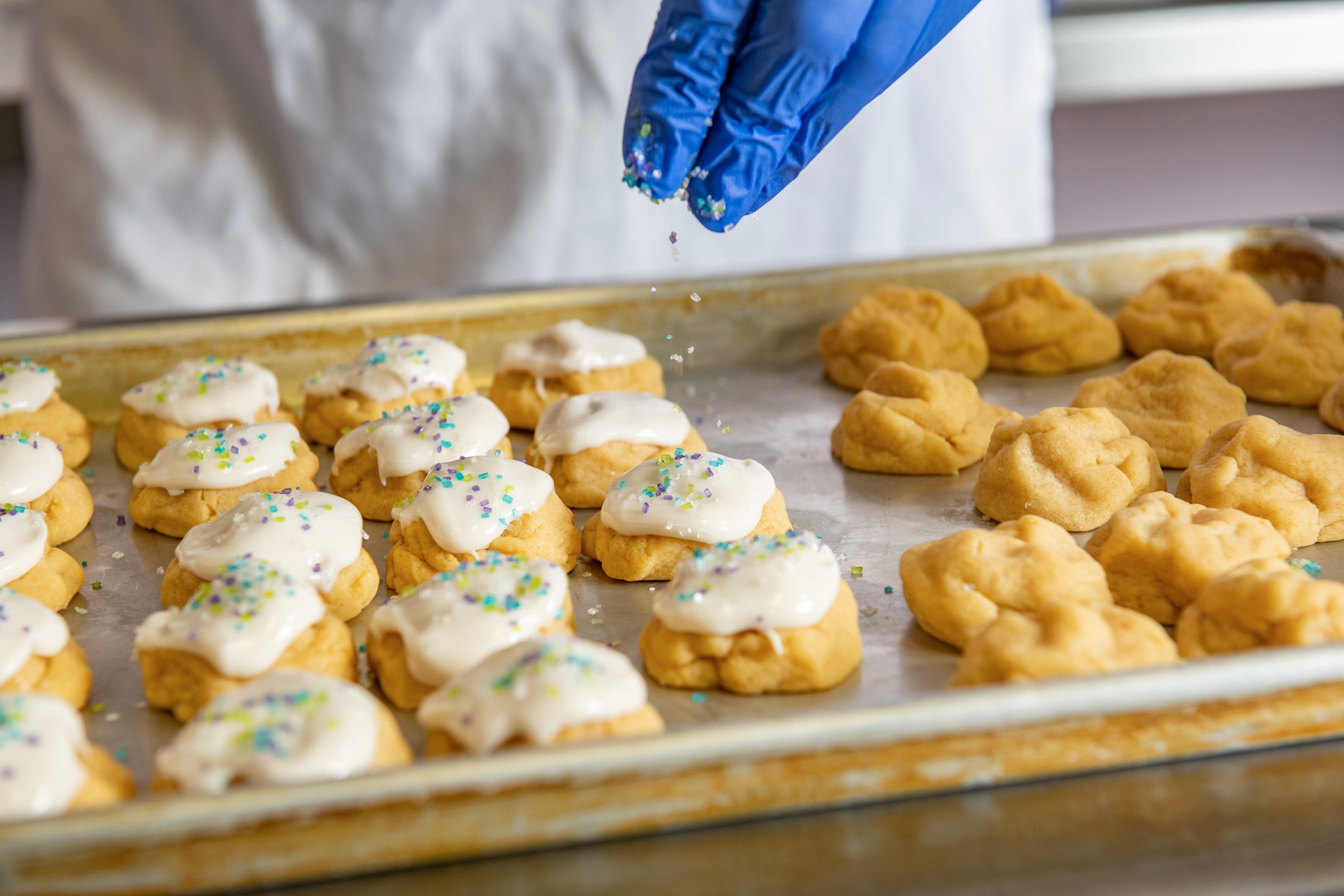 Sprinkling our Iced Sugar Gem cookies.